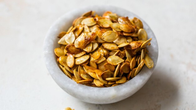 Acorn squash seeds transferred to a bowl.