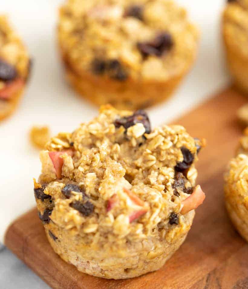 apple oatmeal muffins topped with apple oats and raisins