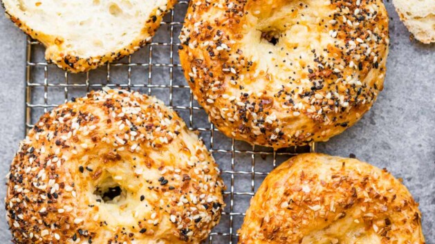 Baked protein bagels with cottage cheese on a cooling rack.