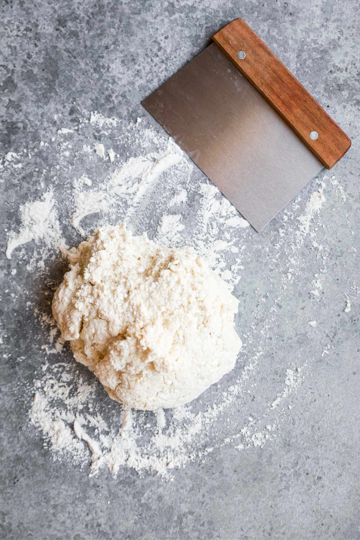 A ball of dough on a floured surface.