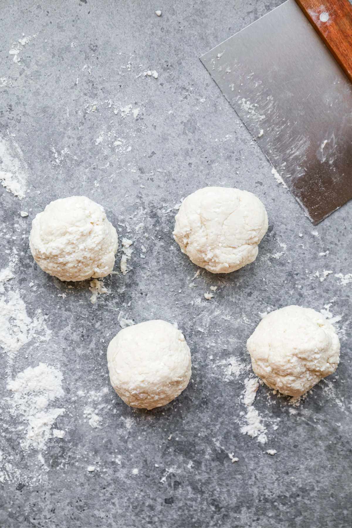 Four small balls of dough.
