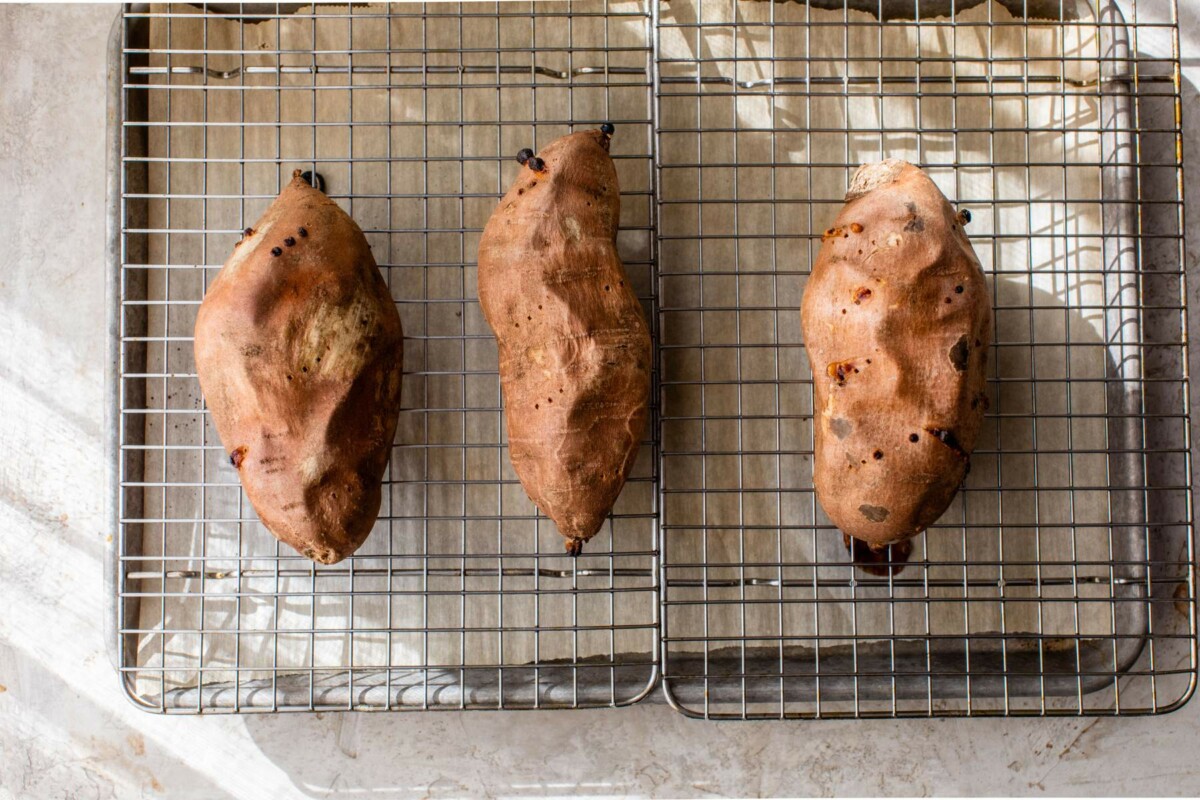 Baked sweet potatoes on a wire rack.