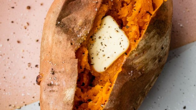 Baked sweet potato topped with a pat of butter.