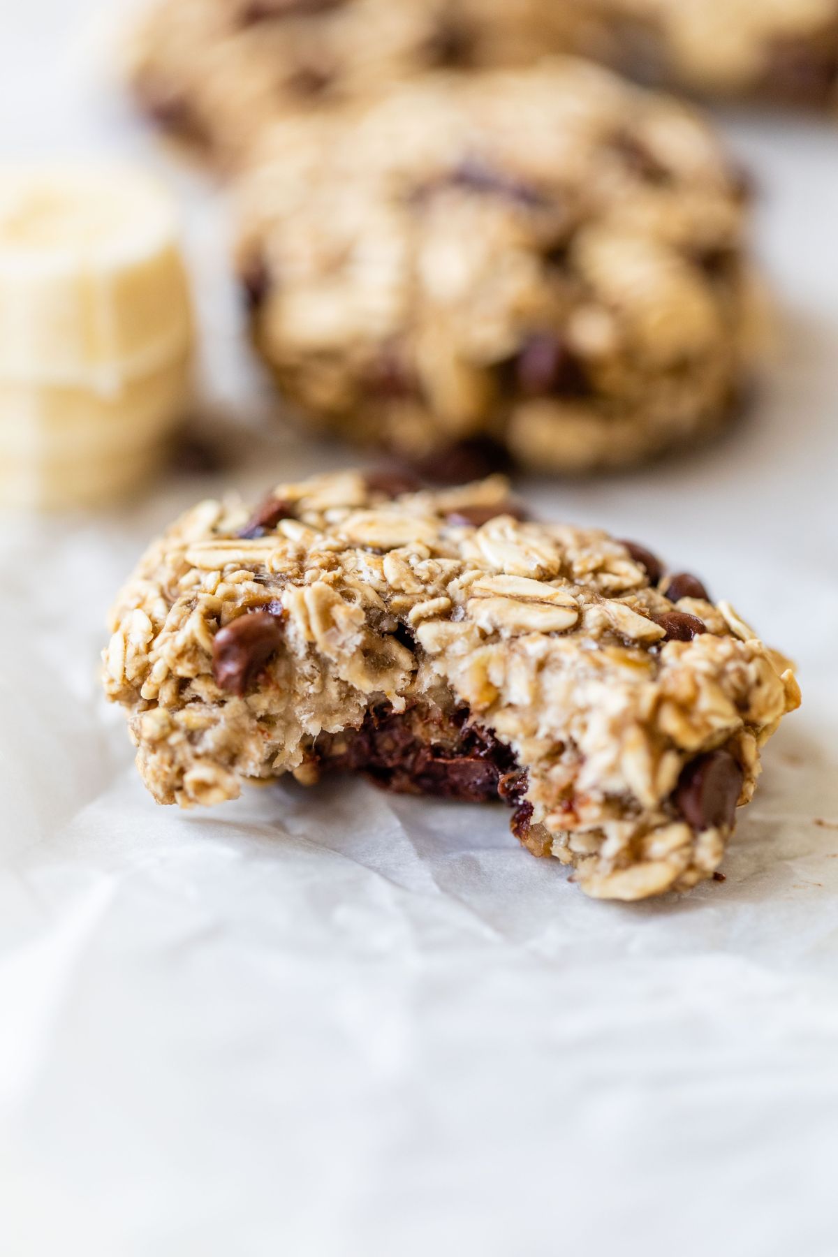 Bite taken out of a banana oatmeal cookie.