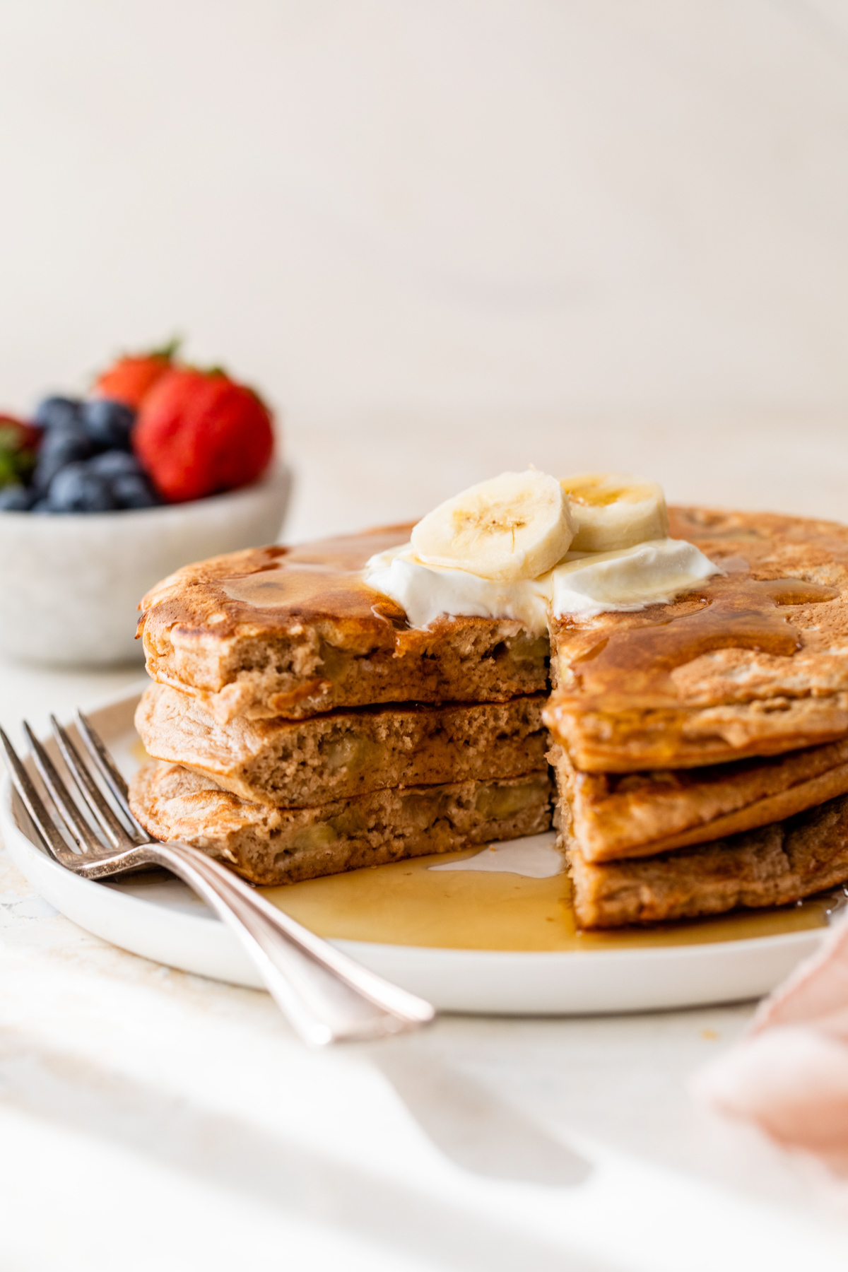 banana protein pancakes with a bit cut from the stack
