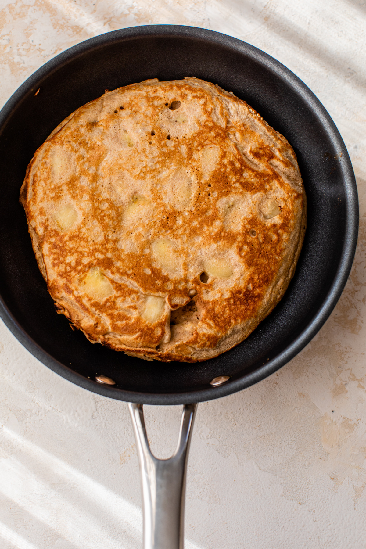 banana banana protein pancake cooked in a pan