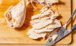 shredding cooked chicken breast off of the bone