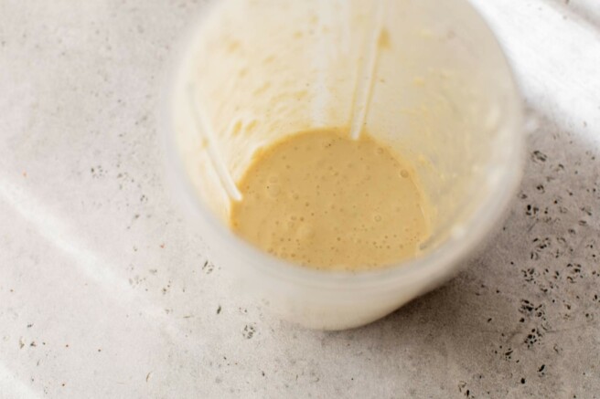 Caesar dressing mixed in a blender.