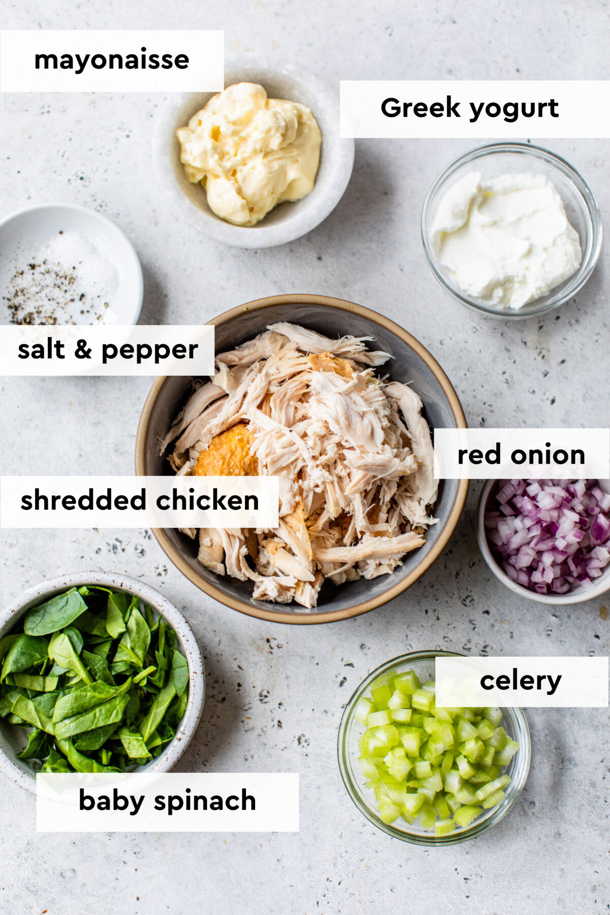 chicken salad ingredients on a white surface
