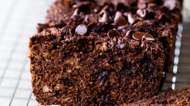 Sliced chocolate banana bread on wire rack.