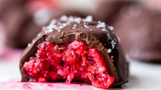 chocolate covered raspberry bites with a bite taken out