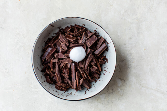 chopped chocolate an coconut oil in a white bowl