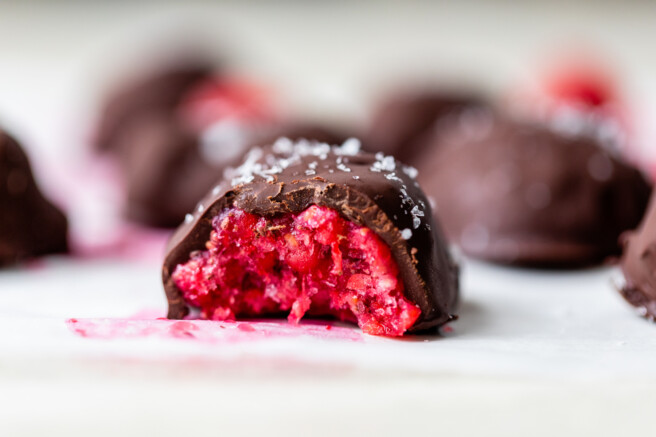 finished chocolate dipped raspberry bite with a bite taken our