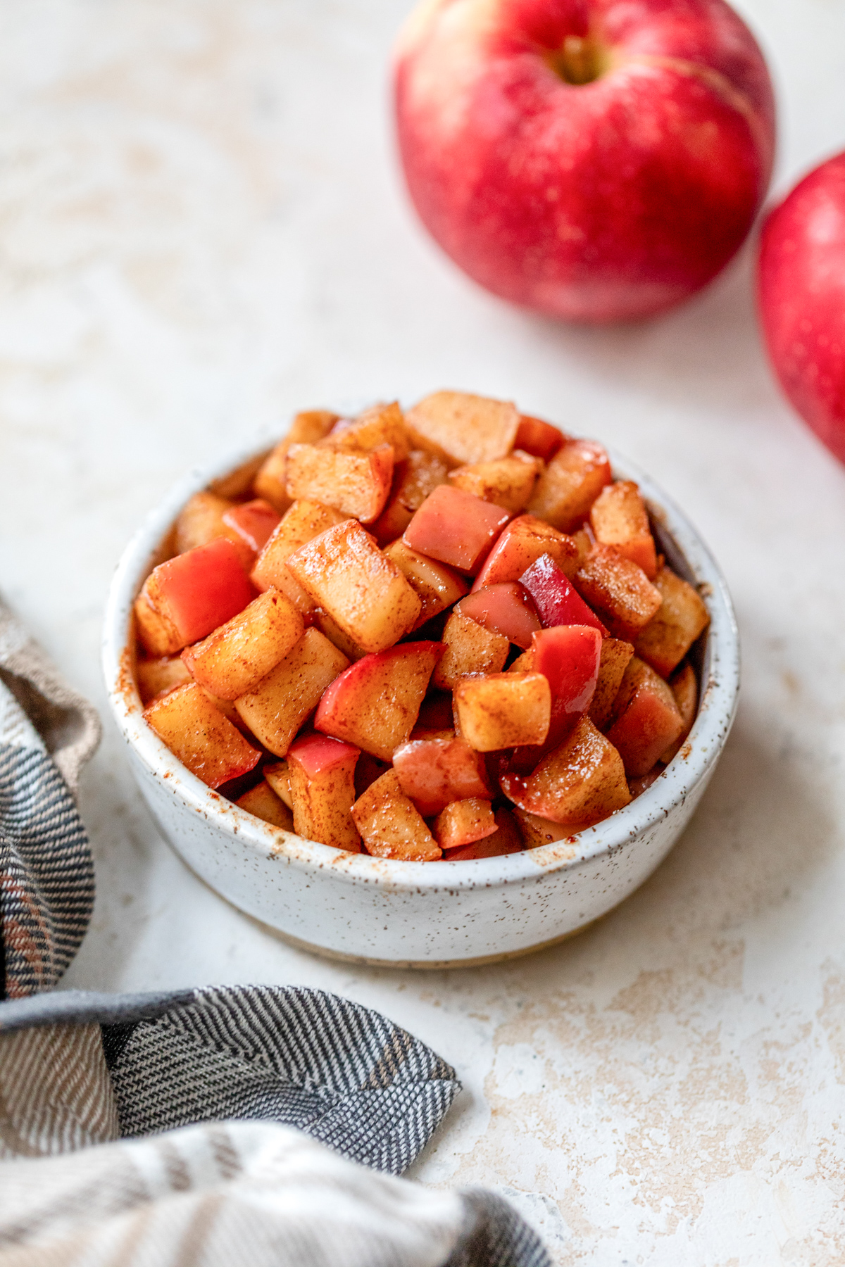 quick chopped cinnamon apples in a small white bowl