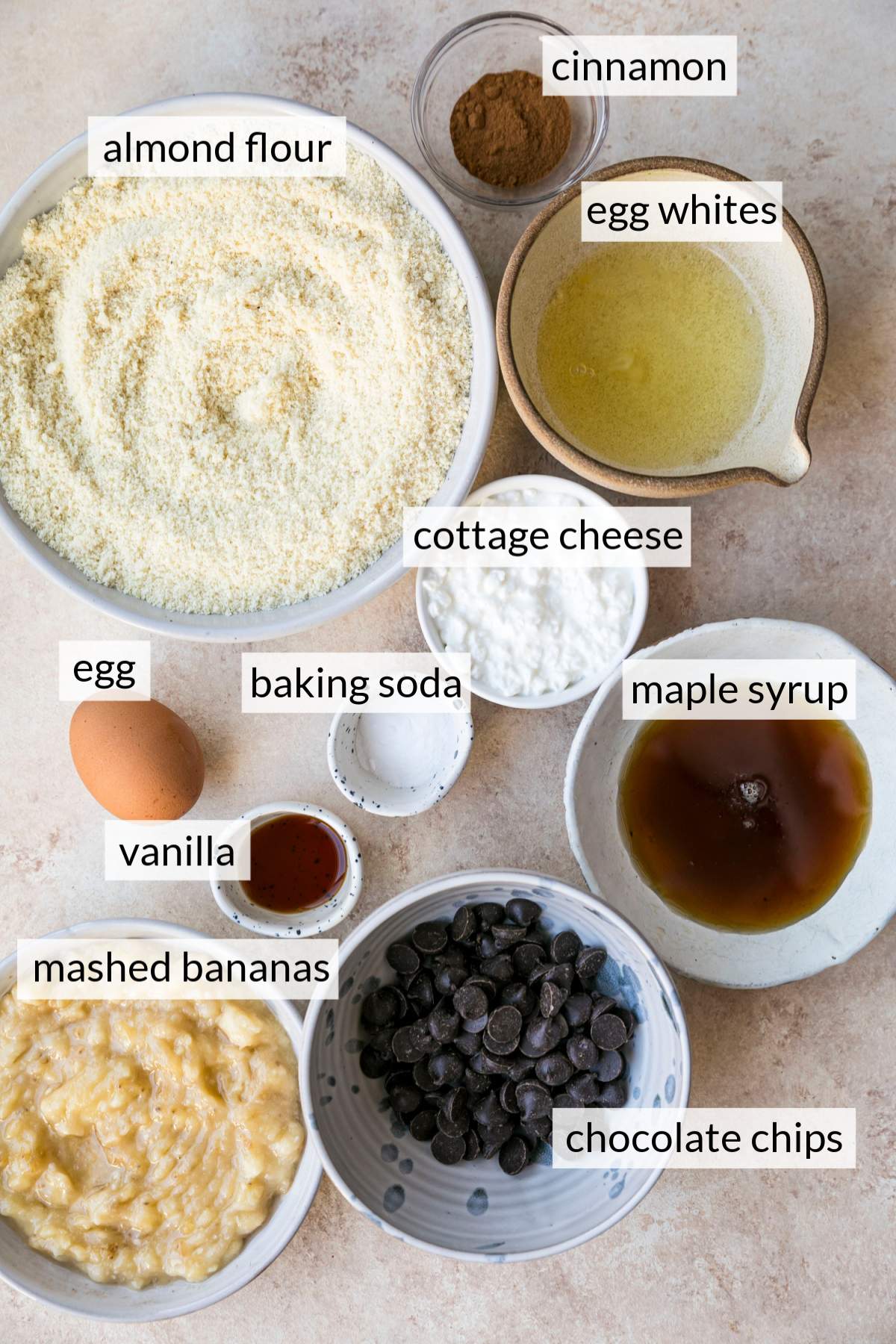 Bowls with almond flour, cottage cheese, maple syrup, egg and mashed bananas.