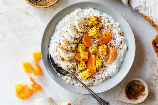 Cottage cheese topped with mango, banana slices, and clementine.