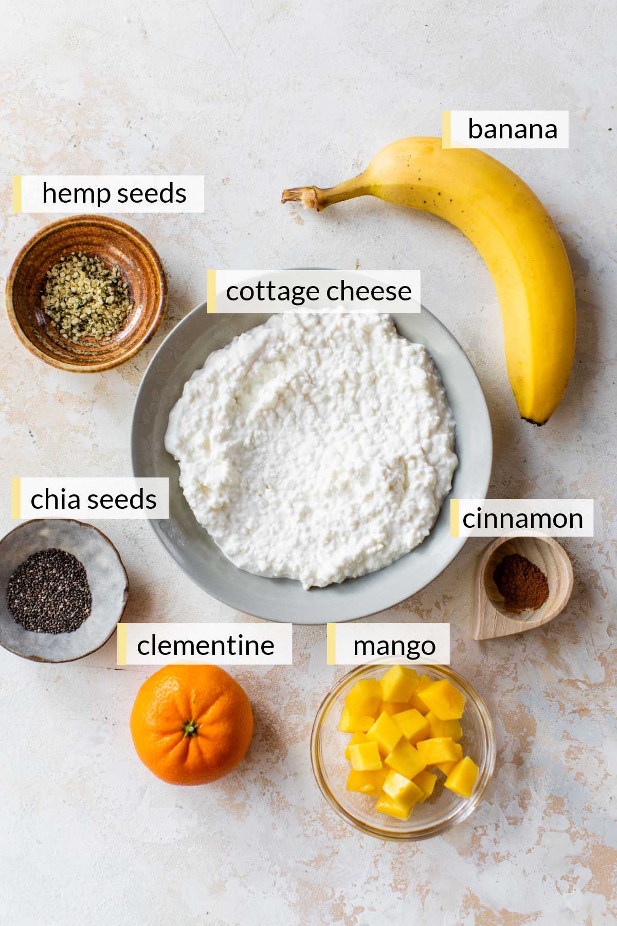 Cottage cheese, chopped mango, seeds, cinnamon, banana, and clementine.