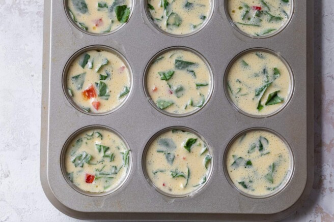 Add the egg mixture to the veggies in the muffin tin.