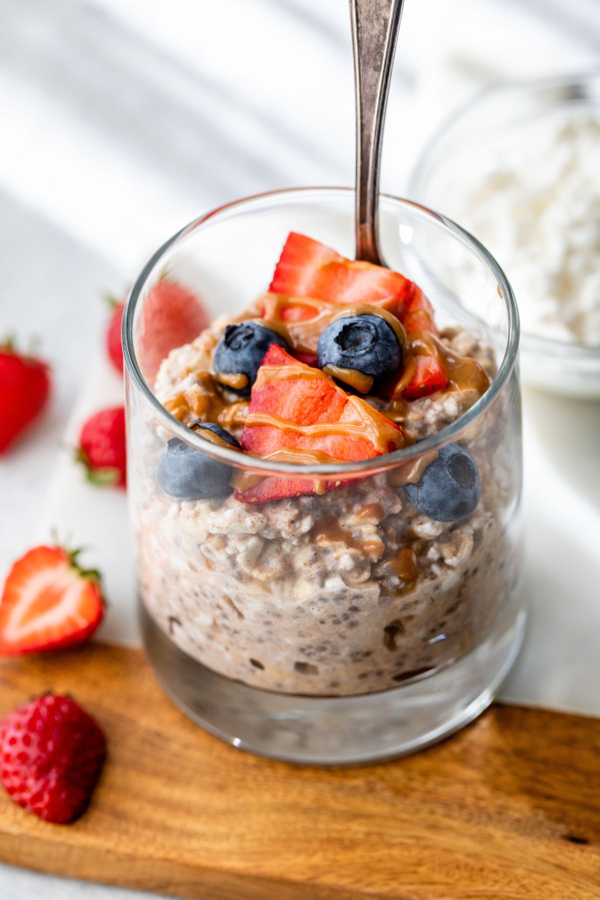 Cottage cheese overnight oats in a small glass with berries.