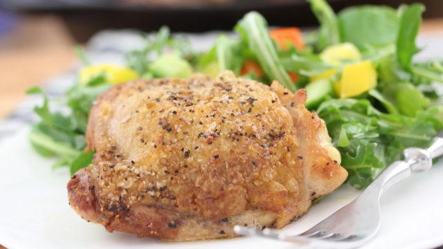 chicken thighs cooked in a cast iron skillet