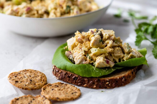 Curry chicken salad on a slice of bread.