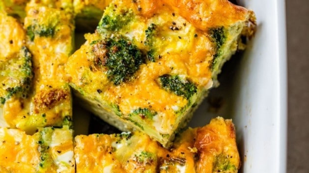 serving broccoli and cheese egg bake out of a casserole dish