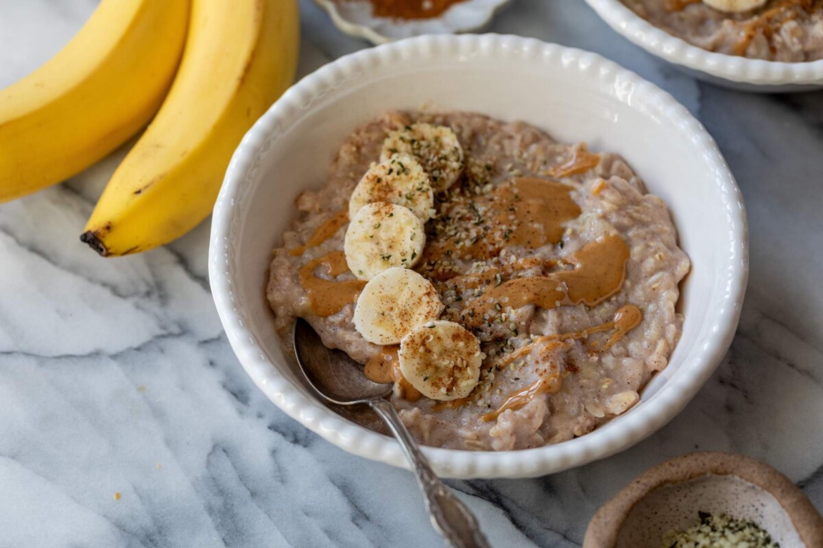 Oatmeal made with egg whites in a bowl with banana slices.