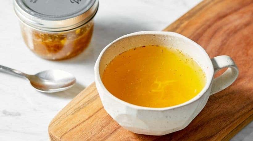 a white mug filled with ginger turmeric tea