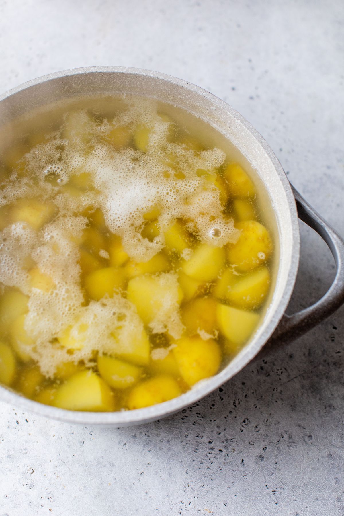 Boiling potatoes in water.