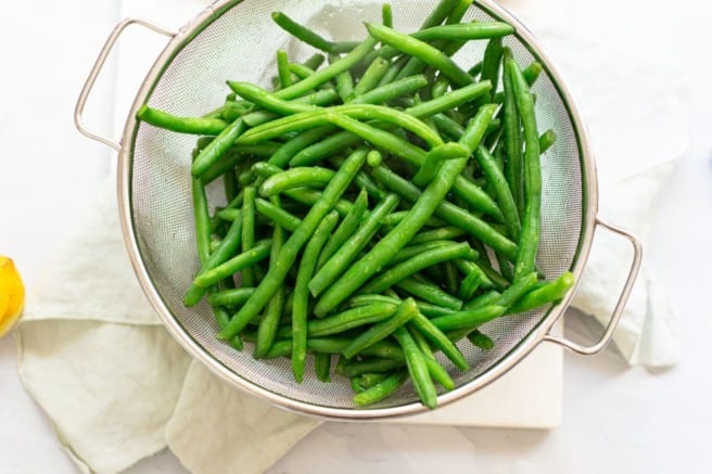 fresh green beans in a colander