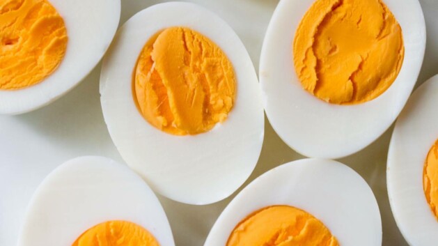 Sliced in half hard-boiled eggs on a white plate.