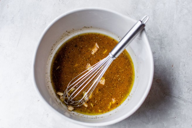 Making vinaigrette in a large bowl.