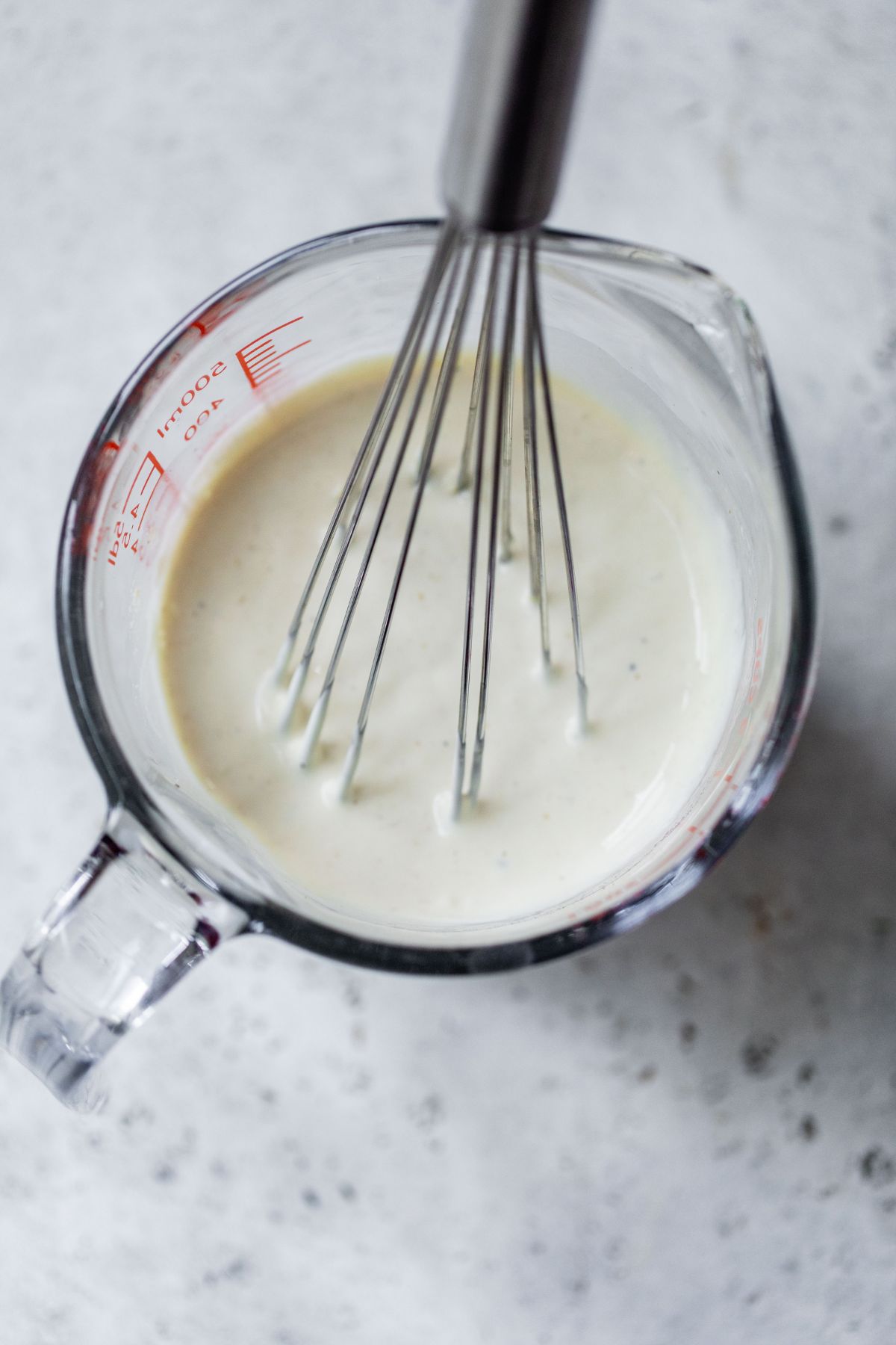 Making dressing for macaroni salad.