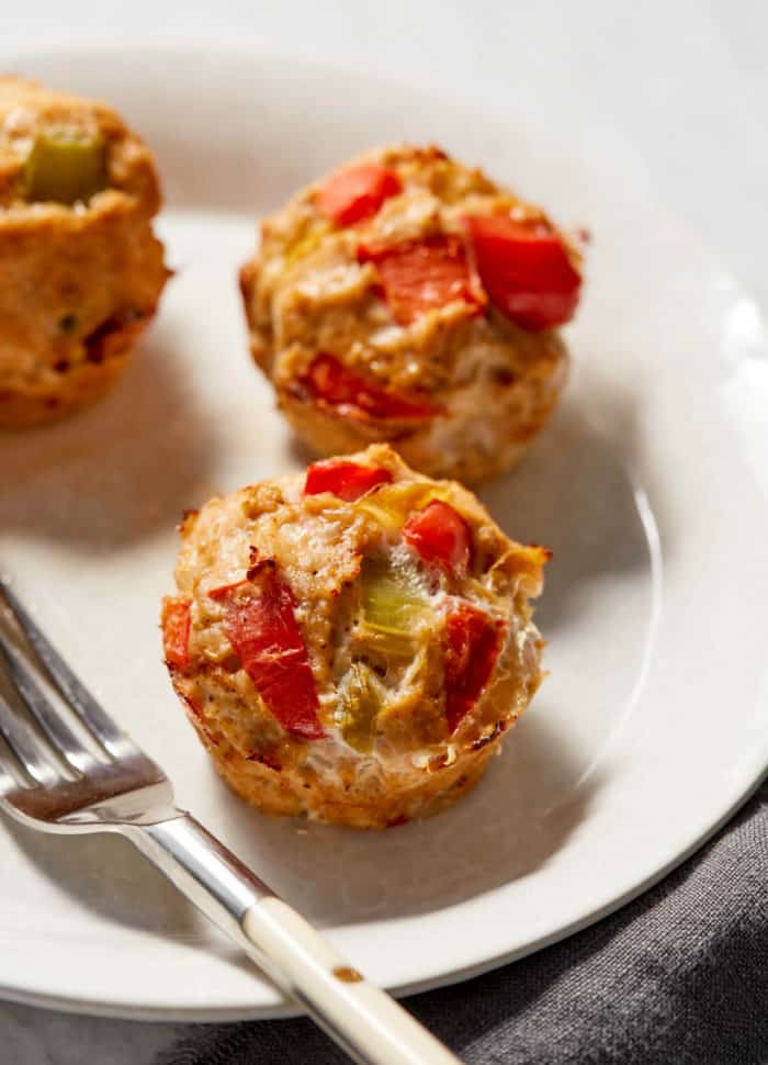veggie and turkey meatloaf muffin on a white plate with a fork