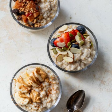 Three bowls of overnight steel cut oats topped with various toppings.
