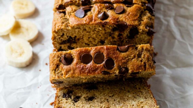 Protein banana bread with chocolate chips, partially sliced.