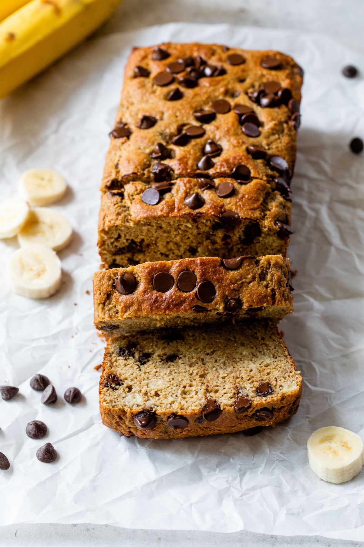 Protein banana bread with chocolate chips, partially sliced.