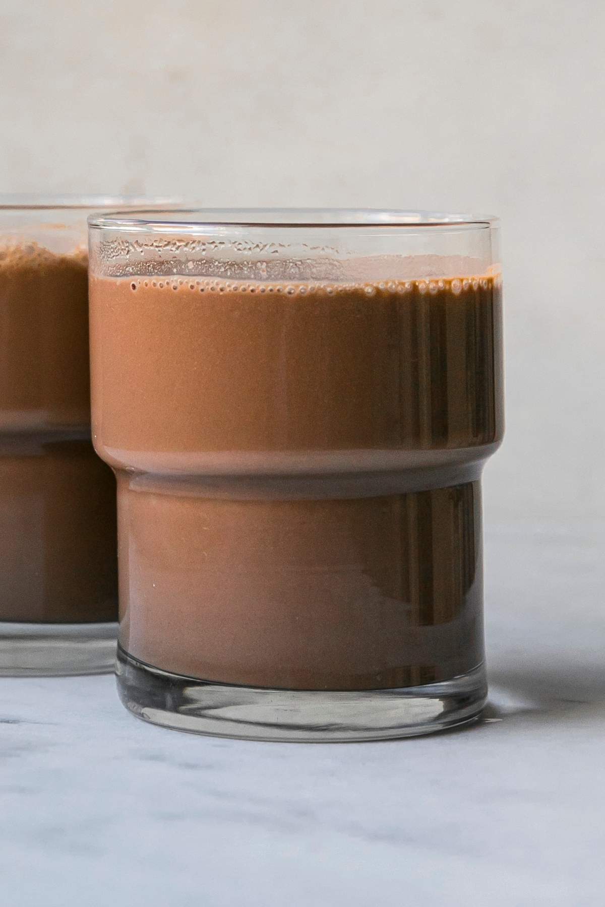 Hot chocolate served in a small glass.