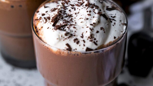 Protein hot chocolate topped with whipped cream and chocolate shavings.