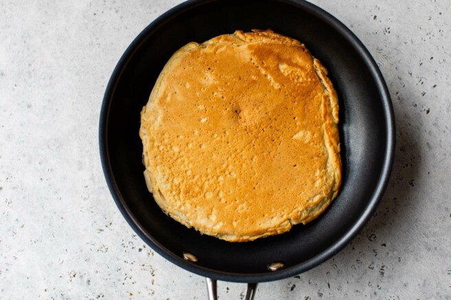 Pancake cooking in a pan.