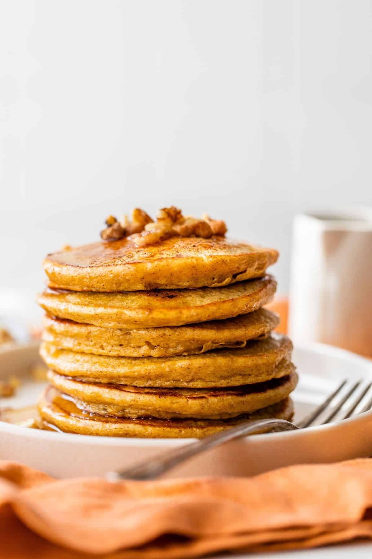 stack of pumpkin pancakes on a small white plate
