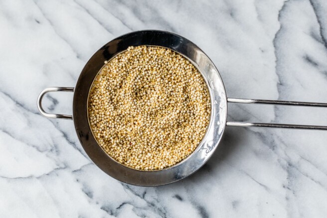 Rinsing quinoa in mesh strainer.