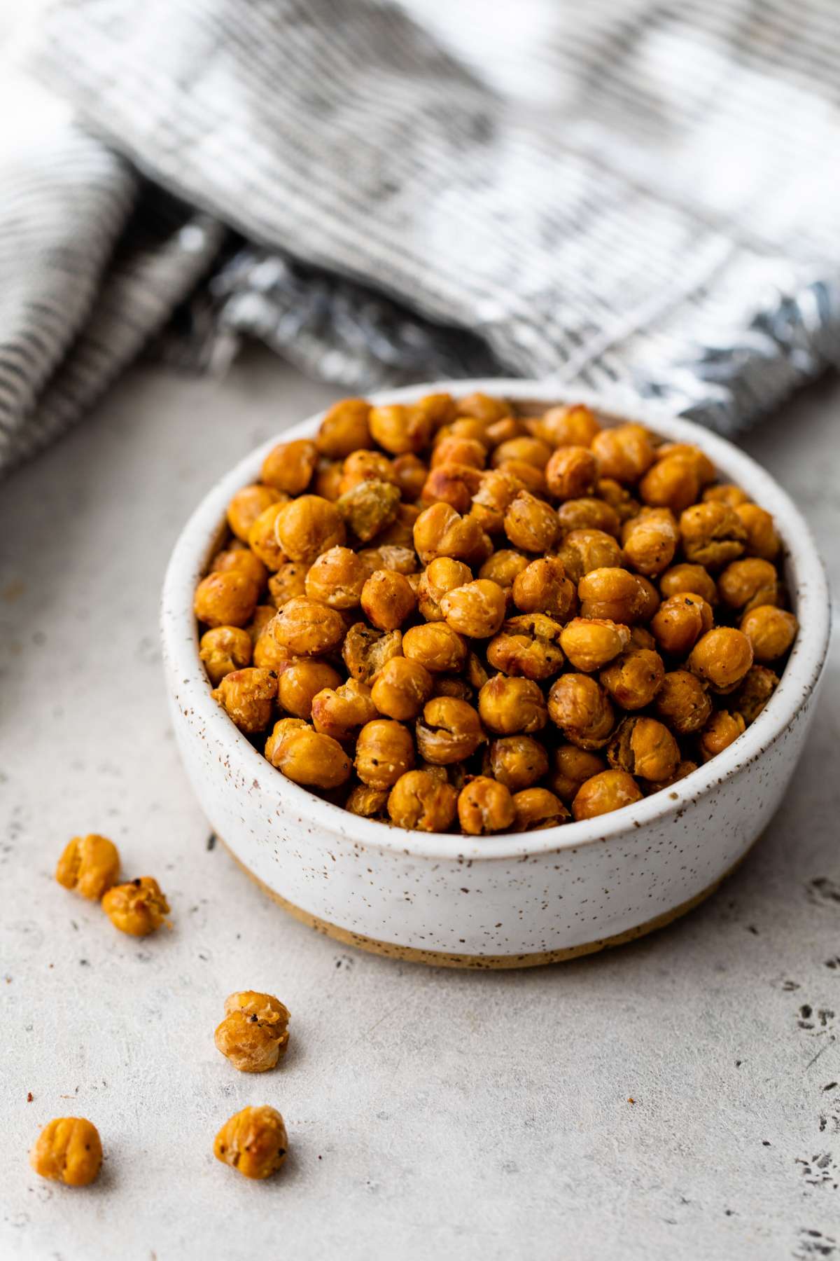 Roasted chickpeas in a small white bowl.