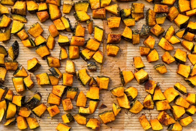 Roasted cubed squash on a sheet pan.
