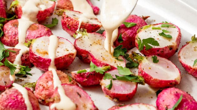 roasted radishes drizzled with lemon tahini sauce