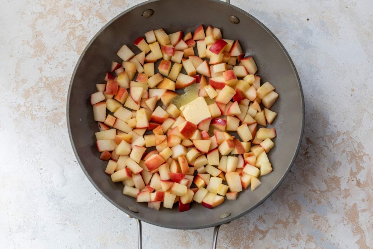 Butter in a skillet with apples.
