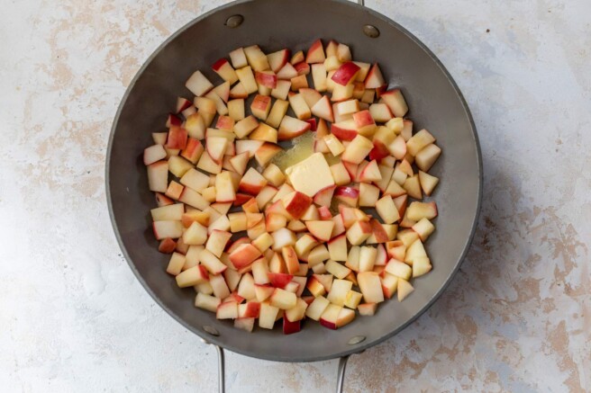 Butter in a skillet with apples.