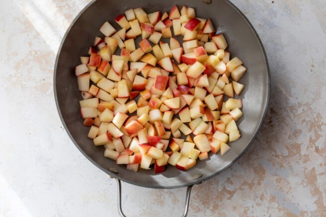 Apples cooking in a skillet.