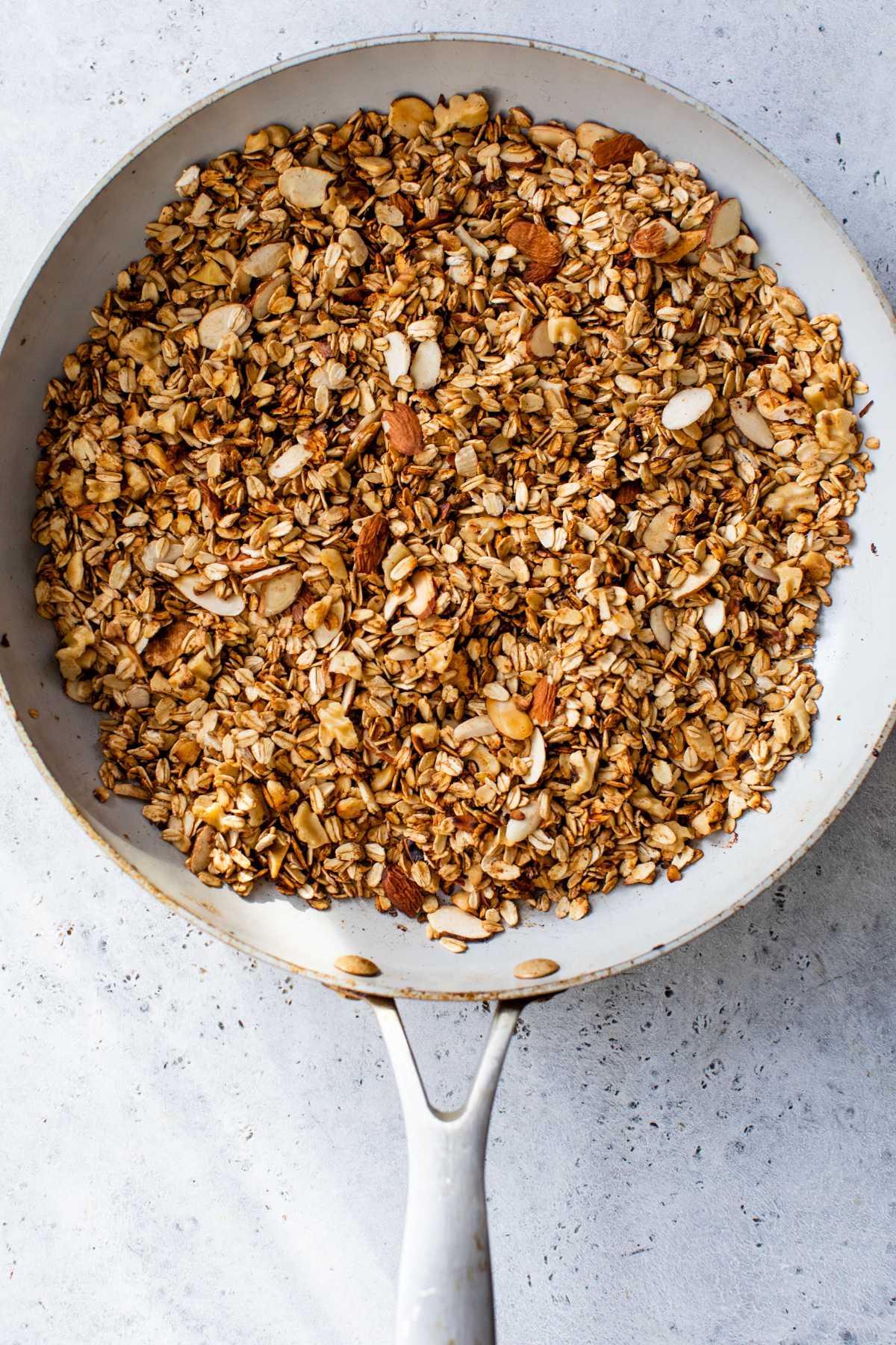 Cooking granola in a pan.