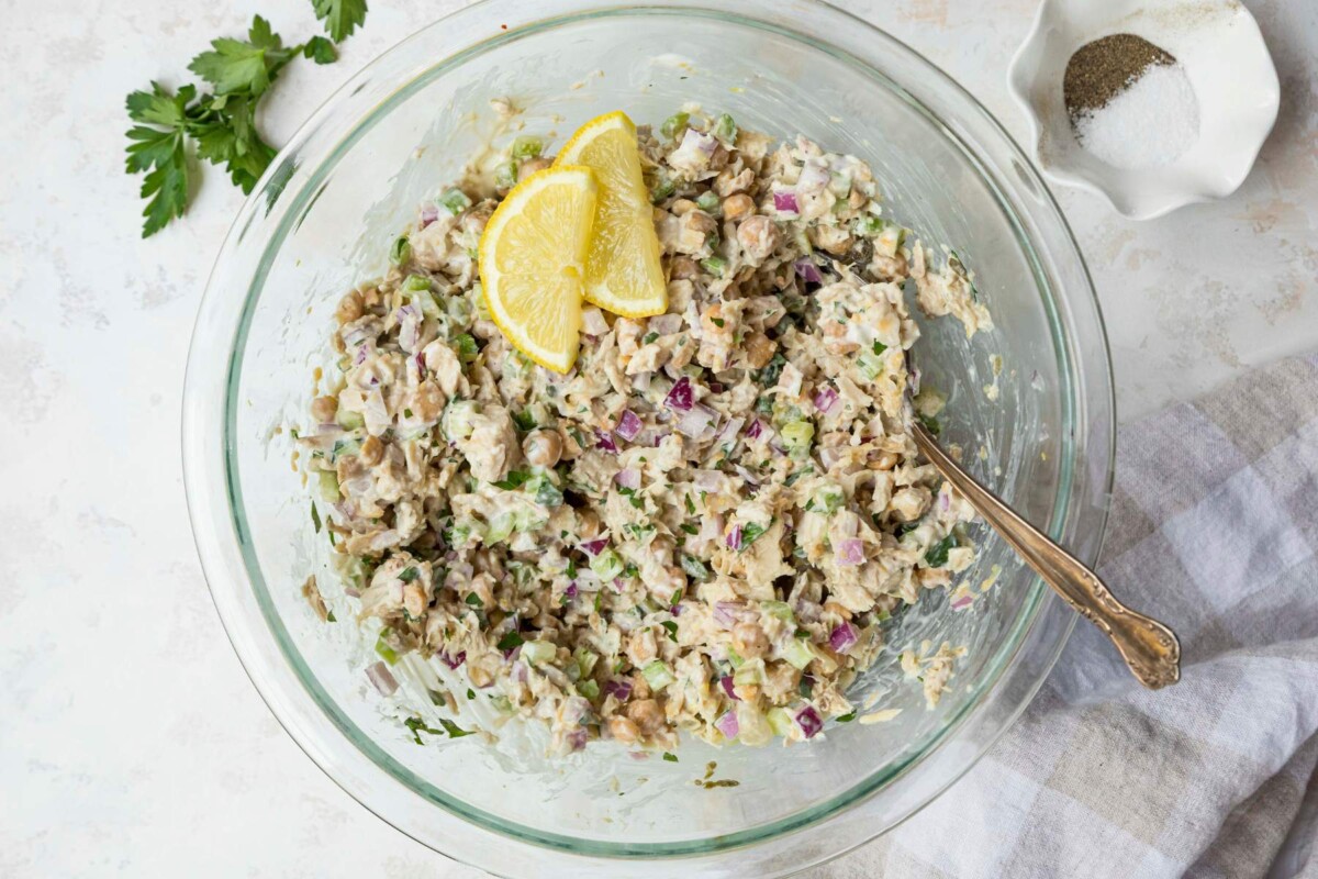 Tuna chickpea salad with lemon slices on top.